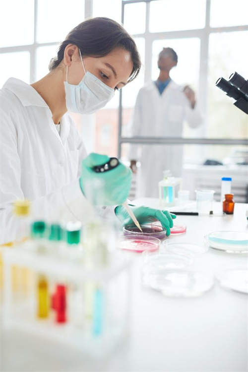 Cleanroom researcher handling a laboratory sample